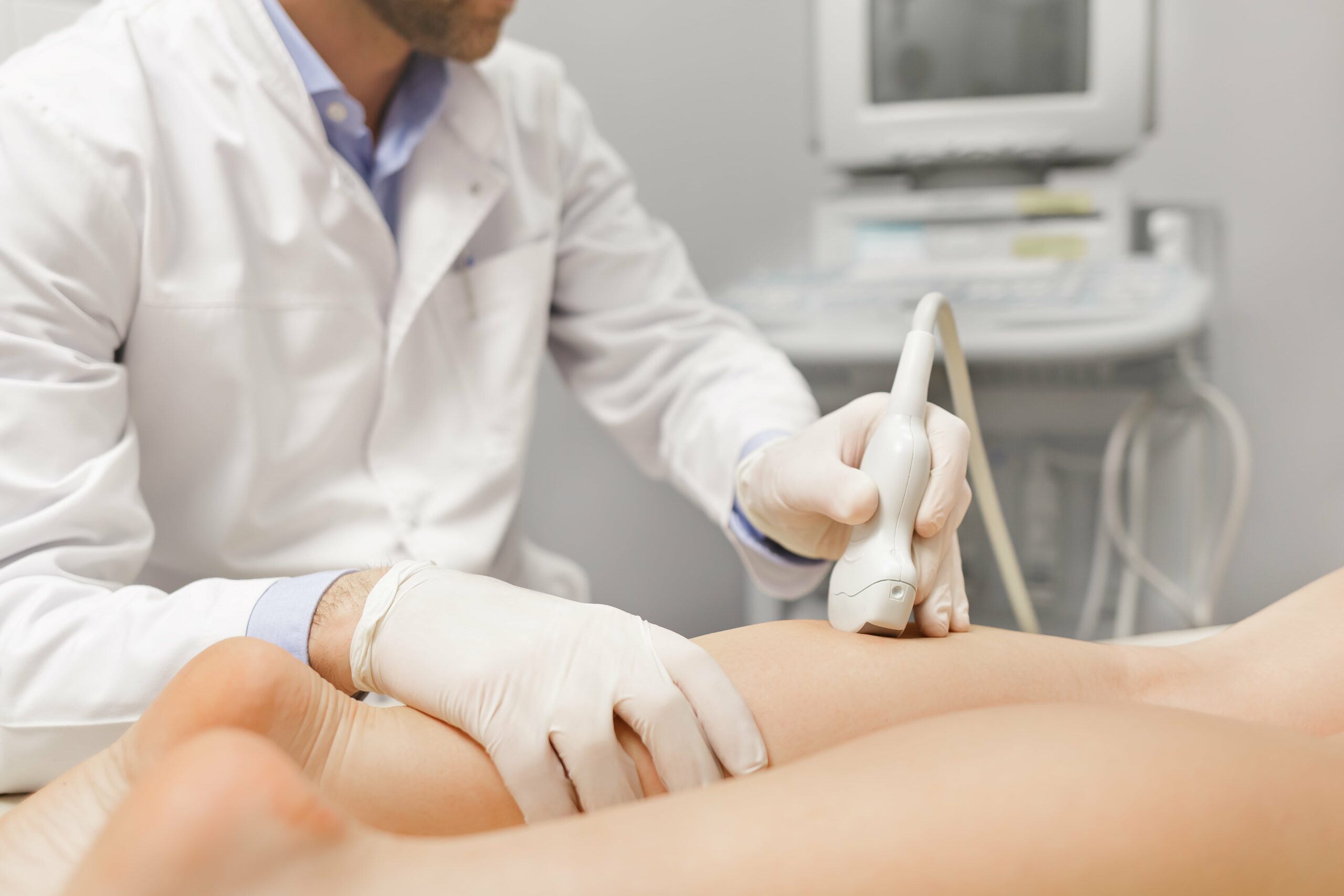 A specialist using an ultrasound machine on a patient